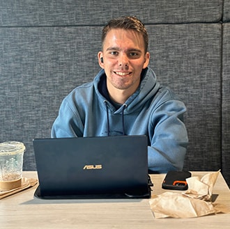 Male Student in Commons with Computer